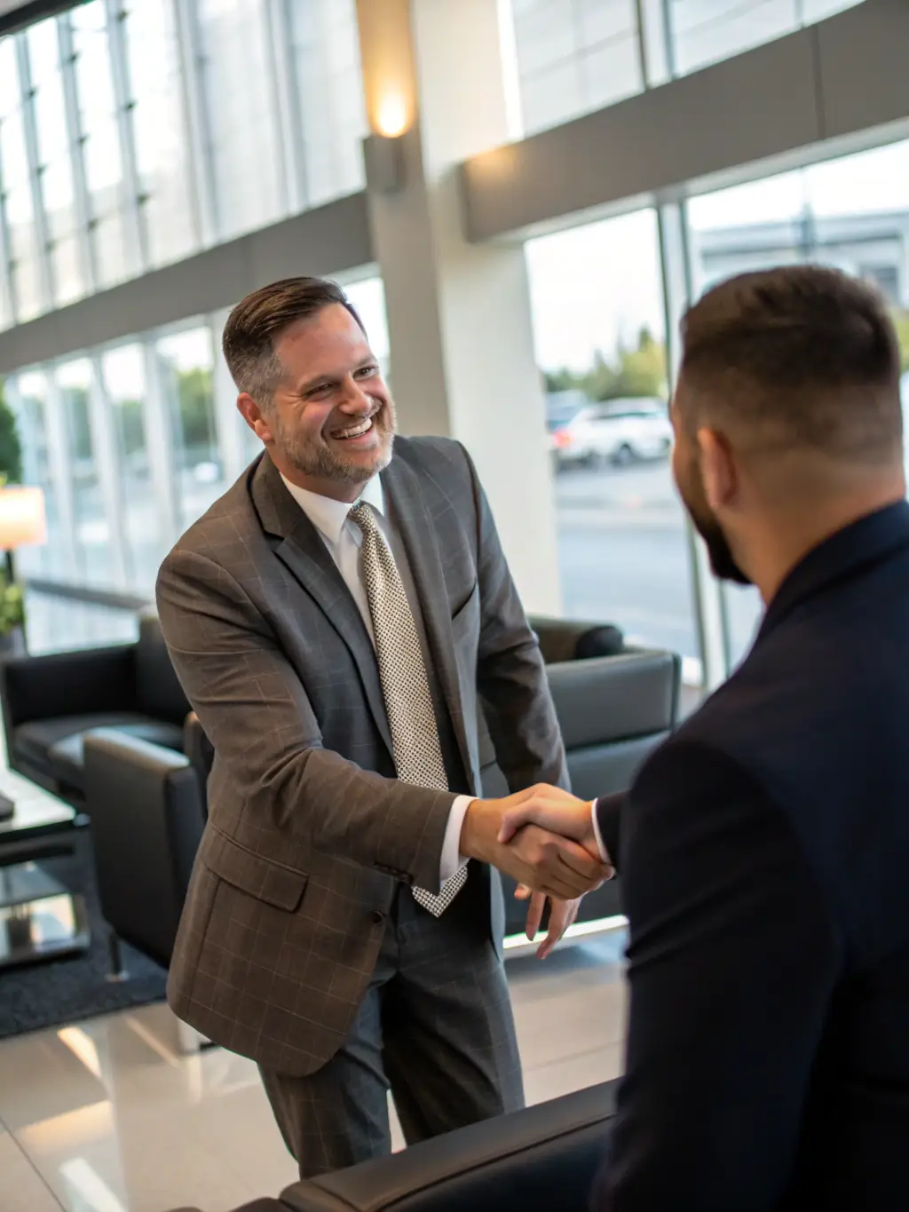 A photo of a satisfied client shaking hands with an EliteToyzauto representative in front of a newly acquired luxury car, symbolizing the personalized service provided.